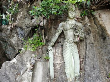 Low angle view of statue against trees