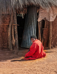 Rear view of man on red outside building