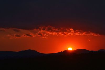 Scenic view of mountains against sky at sunset