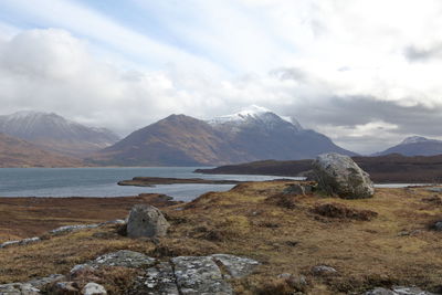 Scenic view of lake and mountains against sky