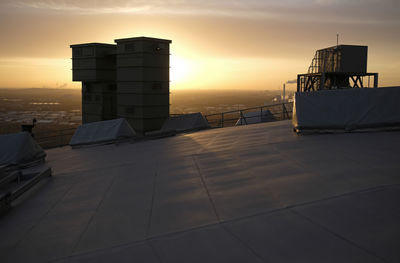 Low angle view of cityscape against sky during sunset