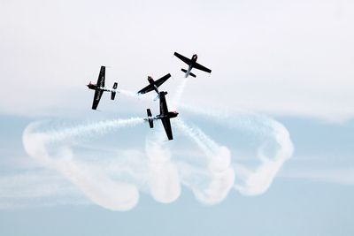 Low angle view of airshow against sky