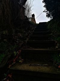 Low angle view of staircase in old building against sky