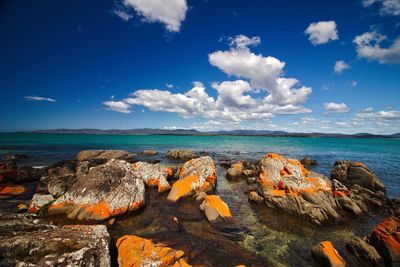 Panoramic view of sea against blue sky