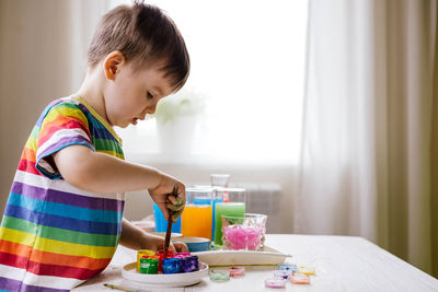 Boy doing painting at home