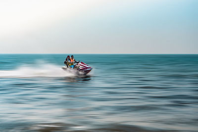 Boat riding in sea against sky