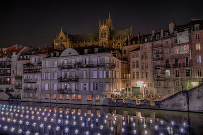 Reflection of illuminated buildings in city at night