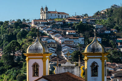 Panoramic view of buildings and trees against sky in city