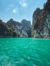 Scenic view of sea and mountains against sky