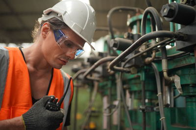 Side view of man working in factory