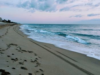 Scenic view of beach against sky during sunset