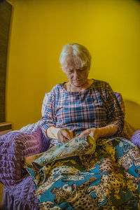 Rear view of woman sitting at home