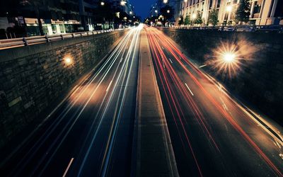 High angle view of light trails on two lane highway at night