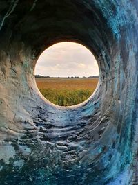 Landscape seen through hole in tunnel