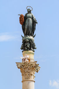 Low angle view of statue of liberty against sky