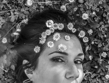 Close-up portrait of woman wearing flowers