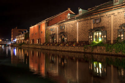 Reflection of illuminated buildings in water at night