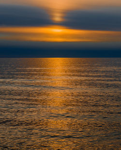 Idyllic shot of sea against orange sky during sunset