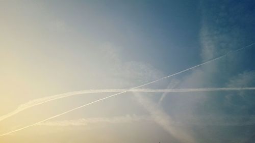 Low angle view of vapor trails in sky