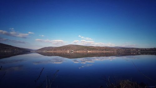 Scenic view of lake against blue sky