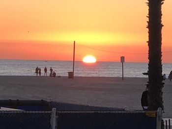 People on beach during sunset