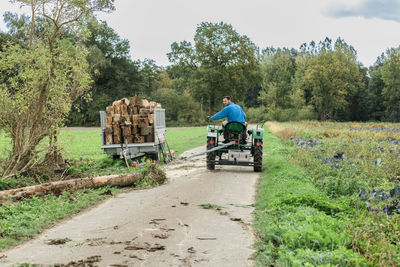 Rear view of man riding motorcycle on road