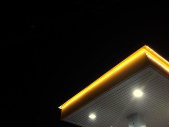 Low angle view of illuminated yellow lights at night