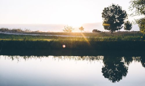 Scenic view of lake against sky during sunset