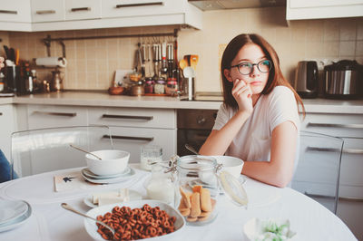 Portrait of woman sitting at home