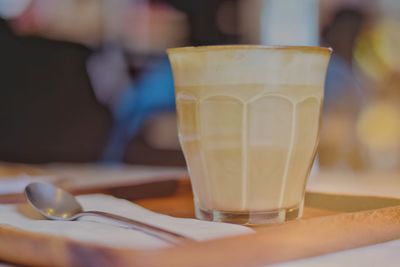 Close-up of coffee in glass on tray at restaurant