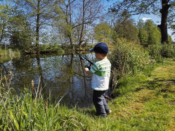 Full length of boy fishing in lake