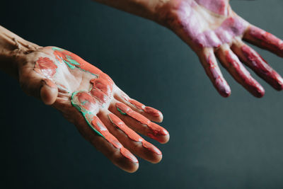 Paint on hands against gray background