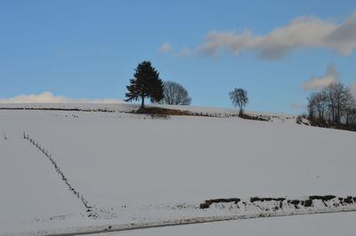 Scenic view of sand dunes against sky during winter