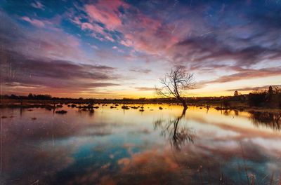 Scenic view of lake against cloudy sky