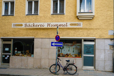 Bicycle sign on building in city