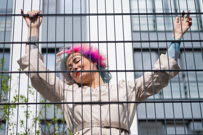 Portrait of a middle-aged woman with multi-colored hair walks on the streets of the city.