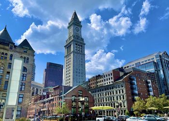 Low angle view of buildings against cloudy sky