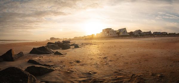 Scenic view of beach against sky during sunset