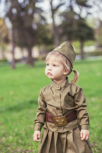 Adorable baby girl in soviet military uniform 