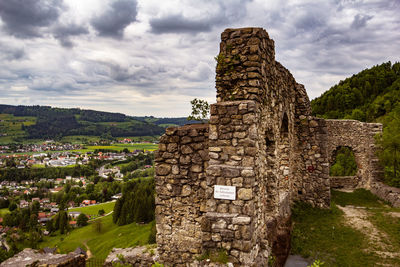 Ruins of building against cloudy sky