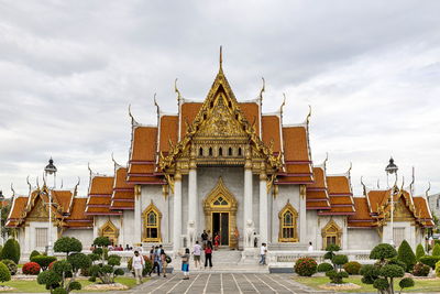 Tourists visiting the marble temple in bangkok, a major destination in thailand.