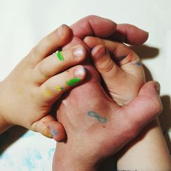 Cropped hands of parent and child