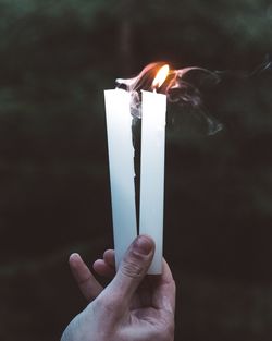 Close-up of hand holding candles