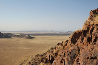 Scenic view of arid landscape against clear sky