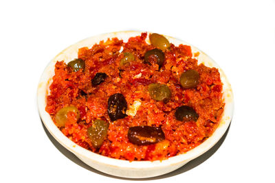 Close-up of pizza in bowl against white background