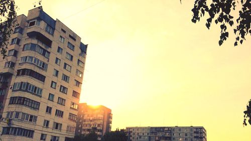 Low angle view of buildings against sky during sunset