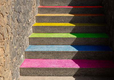 Gay pride flag represented on the steps of a staircase