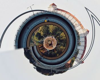 Digital composite image of building and trees against sky