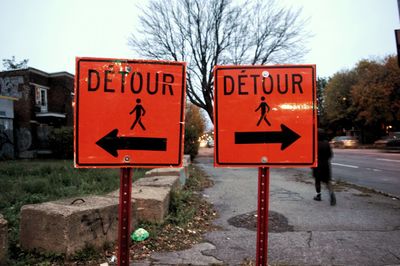 Close-up of road sign against sky