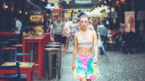 Cool funky teenage girl with crazy hair walking on city streets